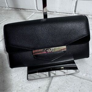 Women’s classic black Kate Spade wallet with scratched front signature plate